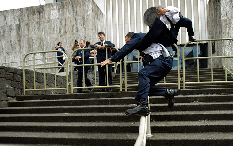 24 hours in pics: Two Costa Rican Supreme Court security guards jump over a barrier 