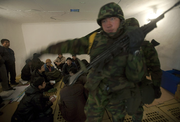 korea crisis: South Korean soldiers take cover inside a bunker  
