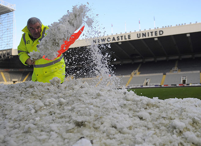 winter weather: A steward clears snow from the side of the pitch at St James' Park