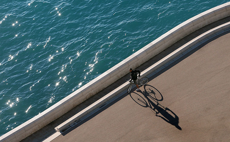 24 hours in picrtures: A cyclist takes a rest on the Promenade des Anglais in Nice