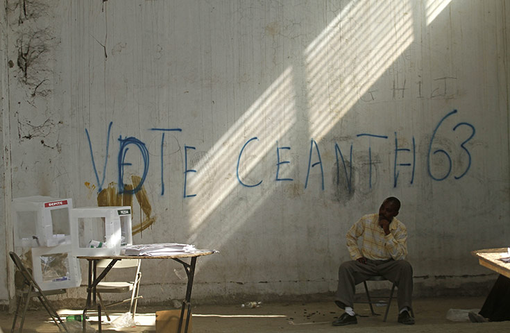 Haiti Elections: An electoral worker watches the ballot boxes 