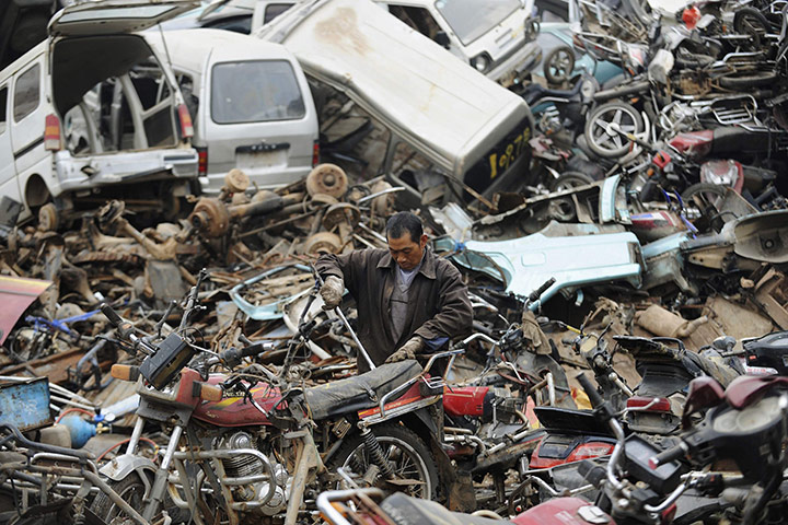 24hours in pics: A worker dismantles motorcycle parts