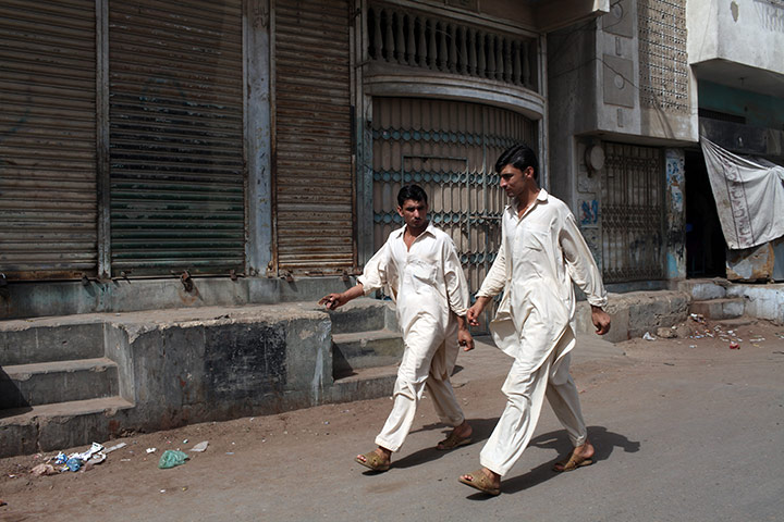 Karachi Pakistan: Men walking in Lyari, one of the oldest neighbourhoods in Karachi