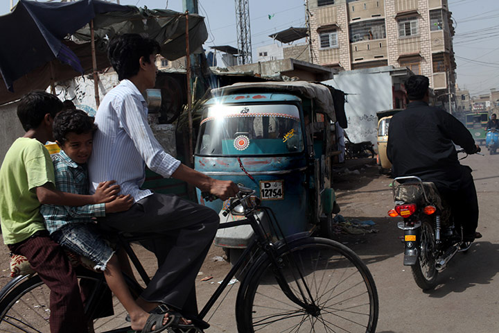 Karachi Pakistan: Vehicles and cyclists on the road in Lyari