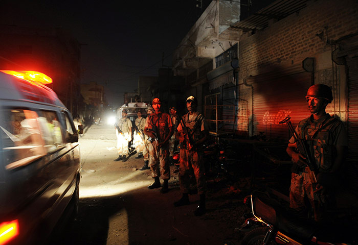 Karachi Pakistan: Paramilitary soldiers cordon off the site following gunmen attacks