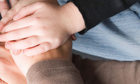 Hands of child and parent