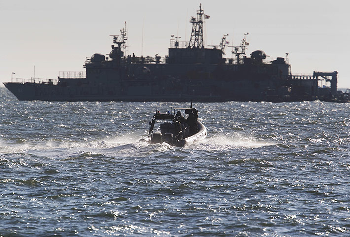 Korea tensions: South Korean sailors return to their naval ship from Yeonpyeong Island