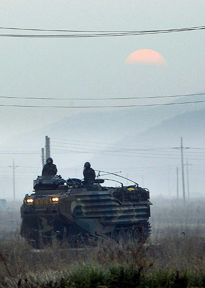 Korea tensions: 30 Nov: A South Korean Marine amphibious vehicle moves down a street