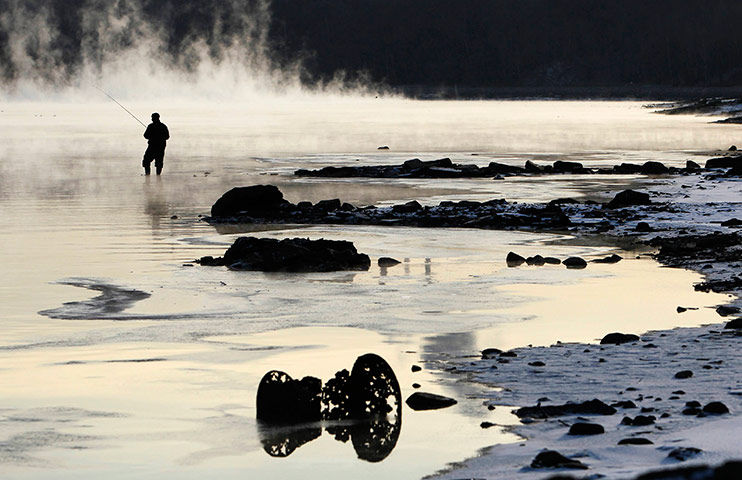 24 hours in pictures: A fisherman casts his line in Moscow River