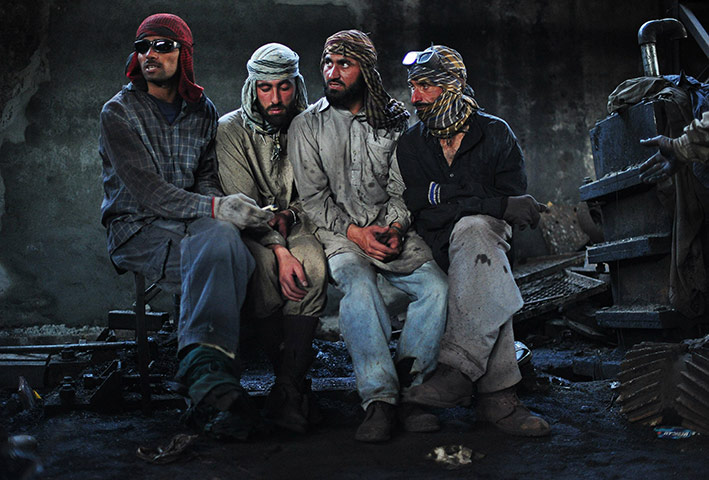 24 hours in pictures: Steel workers take a break after working at Steel Mill Islamabad, Pakistan