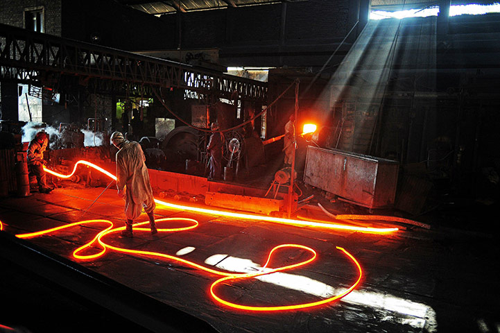 From the agencies: Steel workers are pictured at Ittehad Steel Mill Islamabad