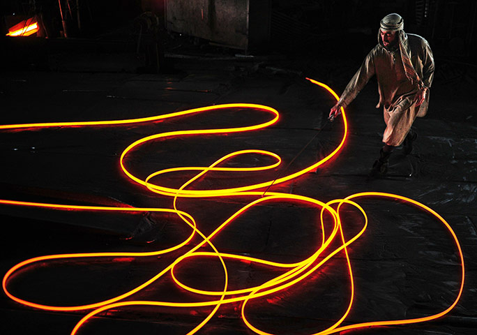 From the agencies: A Steel worker handles molten steel