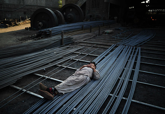 From the agencies: A steel worker sleeps on steel rods 