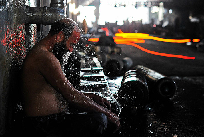 From the agencies: A steel worker washes after working with molten steel 