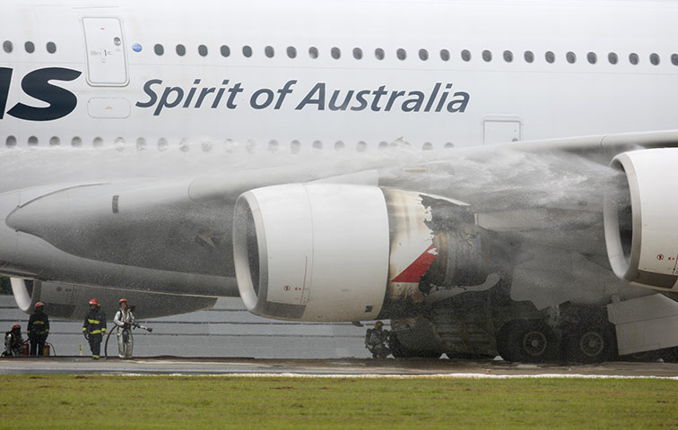 Qantas engine failed: Firefighters surround a Qantas passenger plane