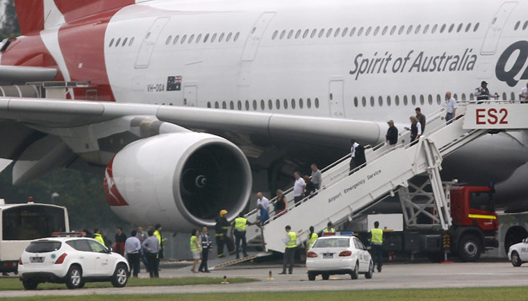 Qantas engine failed: Passengers leave a Qantas Airways 380 passenger plane flight QF32