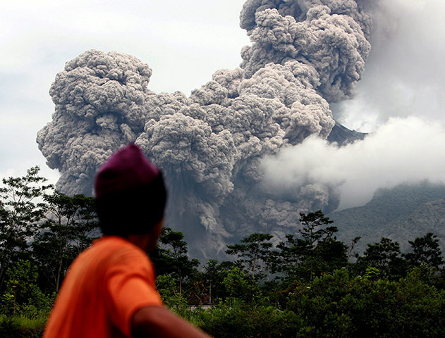 Mount Merapi Update: A man watches the Mount Merapi eruption, Indonesia