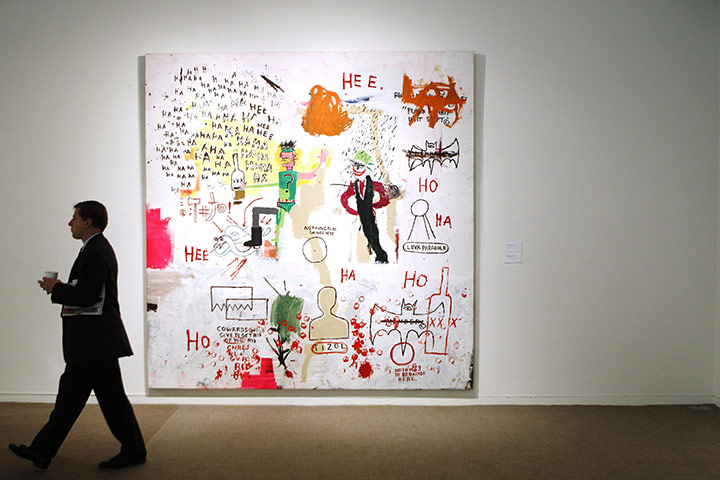 Week In Business: A man walks past Riddle Me This, Batman by Jean-Michel Basquiat