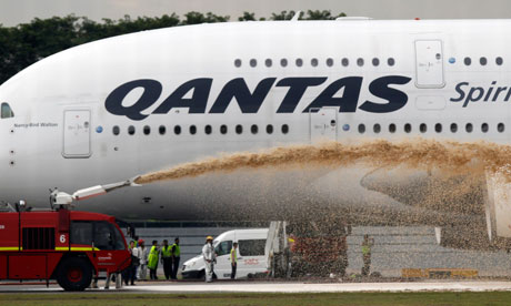 Firefighters spray the Qantas A380 Airbus