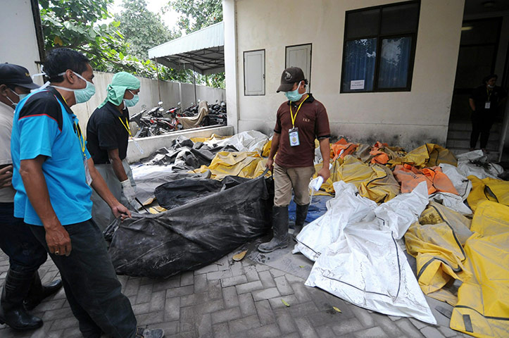 Merapi Volcano Update: Rescue volunteers move the bodies of victims recovered from villages
