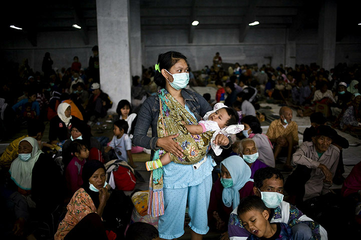 24 Hours: A woman and daughter at evacuation centre after the eruption of Merapi