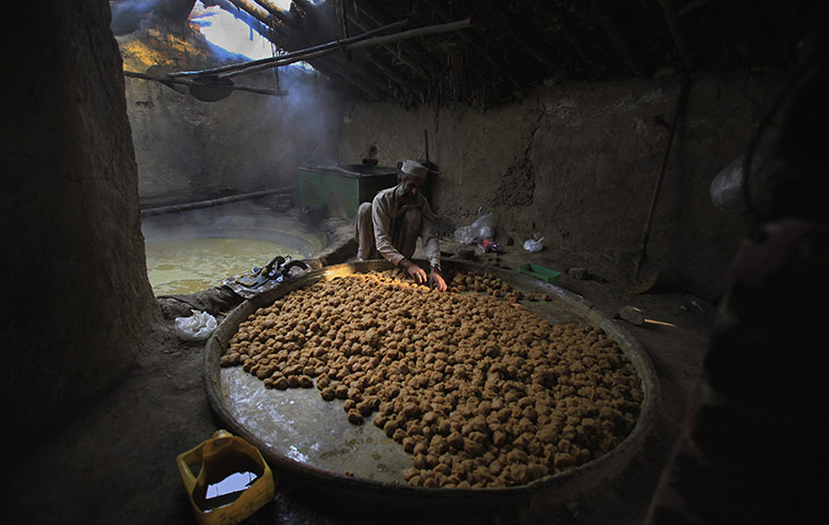 24 Hours: Haji Karim, 60, a flood victim, prepares Molasses at a makeshift factory