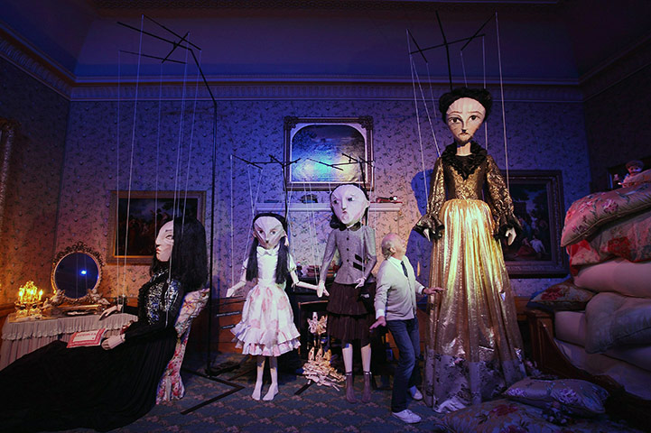 24 Hours: Paul Costelloe stands beneath series of giant puppets in Kensington Palace