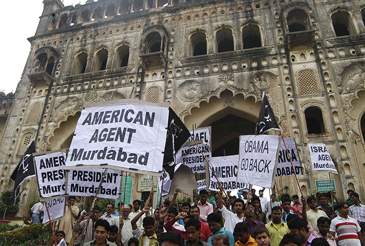 Obama Visit to Asia: Demonstrators hold placards as they participate in a protest in Lucknow