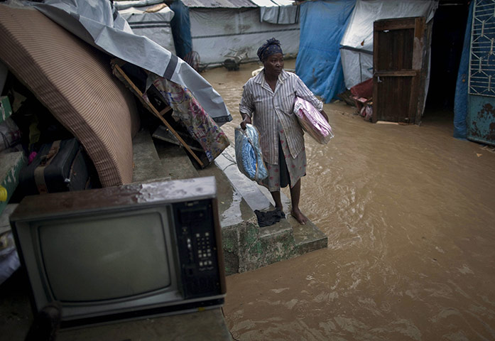 24 Hours: A Haitian woman in a flooded camp for people displaced by the earthquake