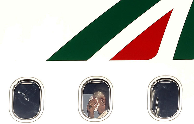 24 Hours: Pope Benedict XVI is pictured through a window from aboard his plane