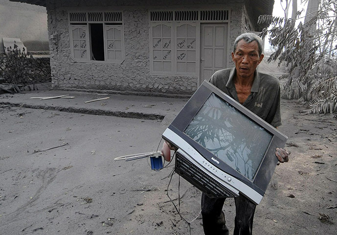 Mount Merapi: An elderly Indonesian villager salvages belongings escaping the erupition