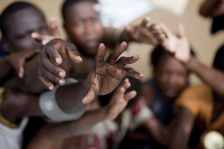 24 hours pics: People try to receive food in Leogane after hurricane Tomas