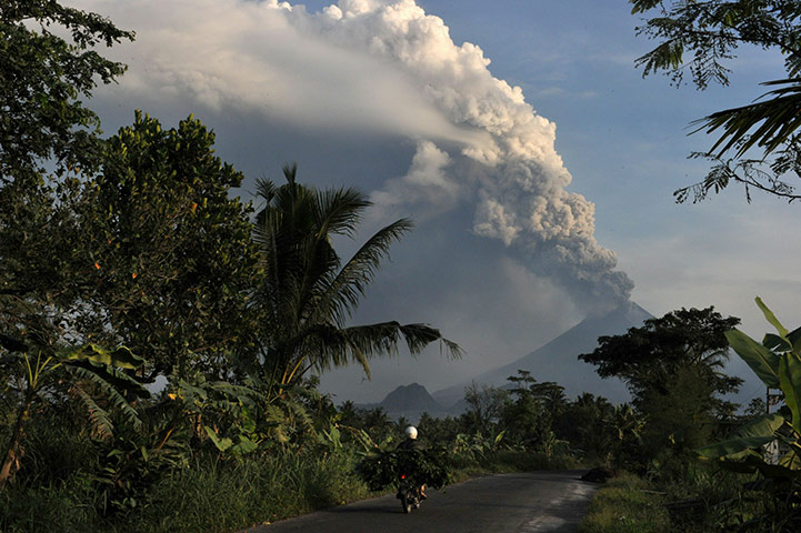 Mount Merapi: A motorist rides as Mount Merapi spews thick ashes 