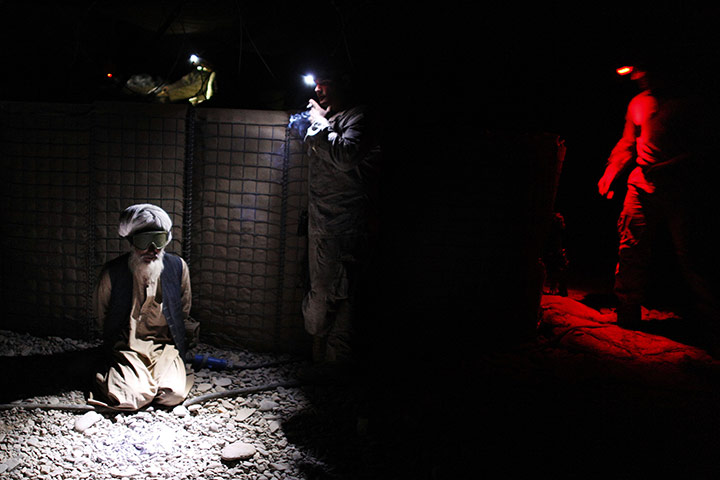 24 hours: An Afghan man is detained by US Marines in Afghanistan
