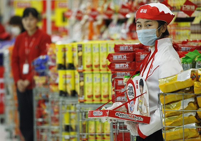 Cameron in China: A Tesco store worker waits the arrival of  David Cameron 