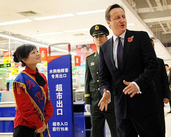 Cameron in China: David Cameron meets staff during a visit to a Tesco supermarket 