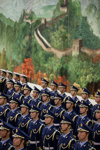 Cameron in China: An honour guard stand beneath a tapestry of the Great Wall of China