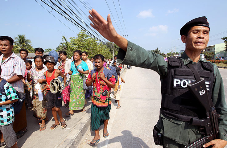 Burma refugees: A Thai border patrol policeman guards as Burmese refugees