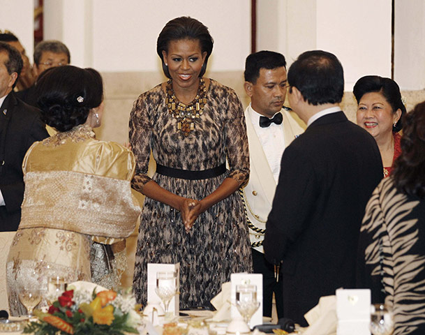 Obama indonesia: Michelle Obama is greeted by other guests as she arrives at a state dinner