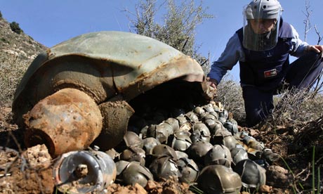 An expert from the Mines Advisory Group inspects an Israeli cluster bomb in Ouazaiyeh, Lebanon