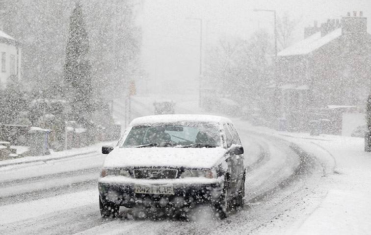 Snow today: A motorist drives through heavy snow in Manchester