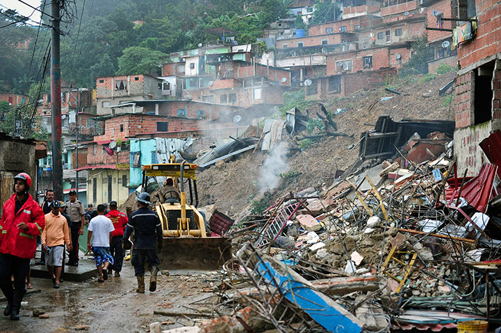 Venezuela floods: Firefighters work at the Tamanaquito neighbourhood
