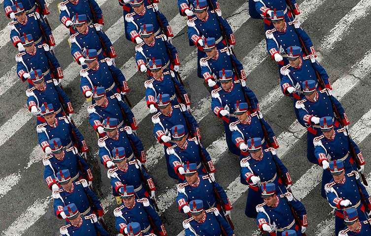 24 hours in pictures: Soldiers march during a military parade to celebrate Romania's National Day