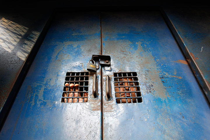 24 hours in pictures: An activist from Bangladesh looks through window of a prison van