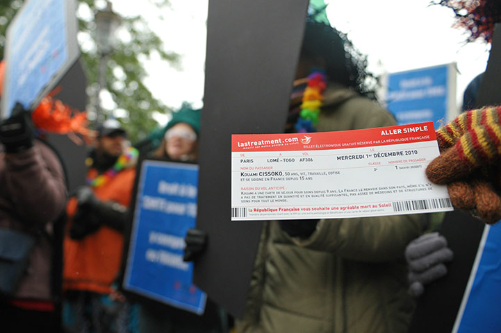 AIDS World day: An AIDS activist shows a false airplane ticket 