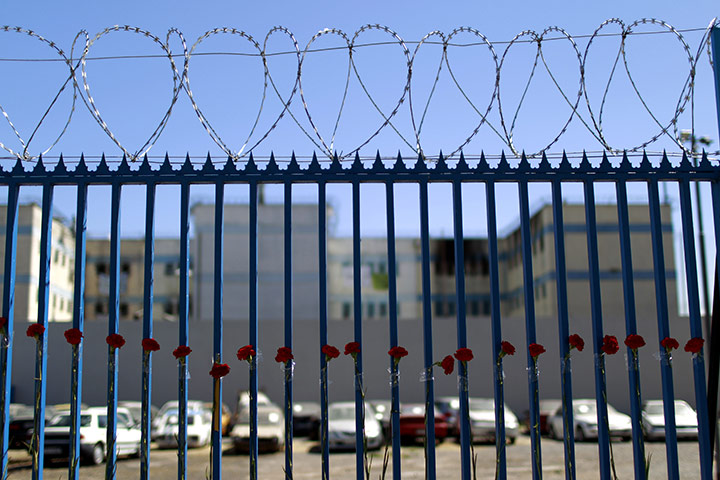 24 hours in pictures: Santiago, Chile: Flowers line a fence near the San Miguel prison