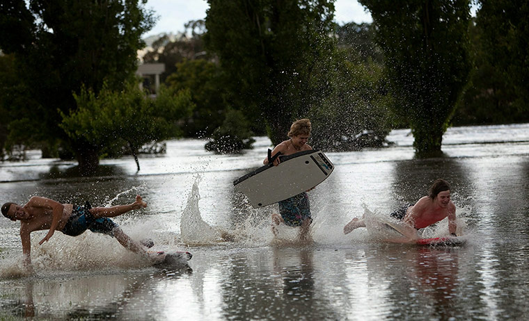 24 hours in pictures: Queanbeyan, Australia: Local teenagers play in flood water