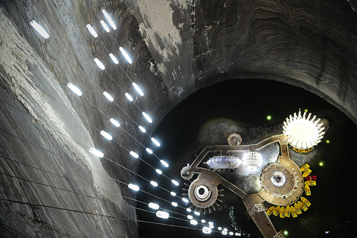 24 Hours in Pictures: A small boat quay is seen on a lake at the bottom of Turda salt mine