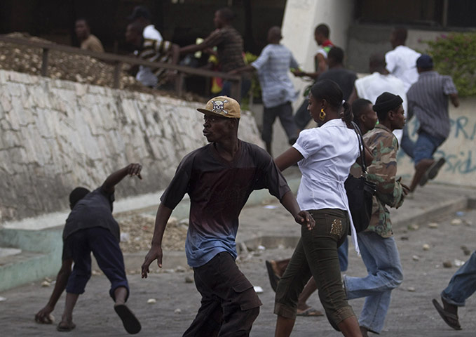 24 Hours in Pictures: People run away from UN peacekeepers in Haiti