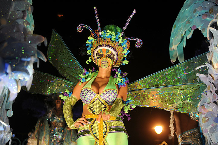 24 Hours in Pictures: A woman stands on a float during the Light Festival Parade in California